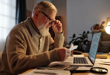 Business professional reviewing financial documents and analysing return on investment data for commercial water recycling systems.