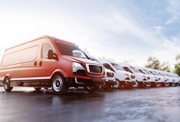A fleet of red and white trucks that’s been cleaned with a tailored truck washing system for optimal cleaning performance.