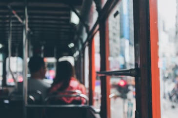 Commuters sitting on a clean tour bus after it having gone through a commercial wash system that morning