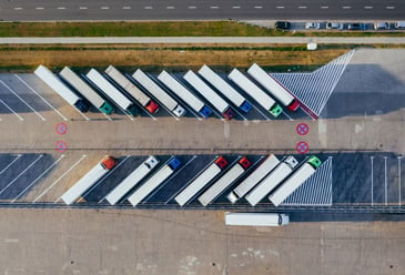 A bird's eye view of a large number of lorries, showing the reduction of risk and safer operation