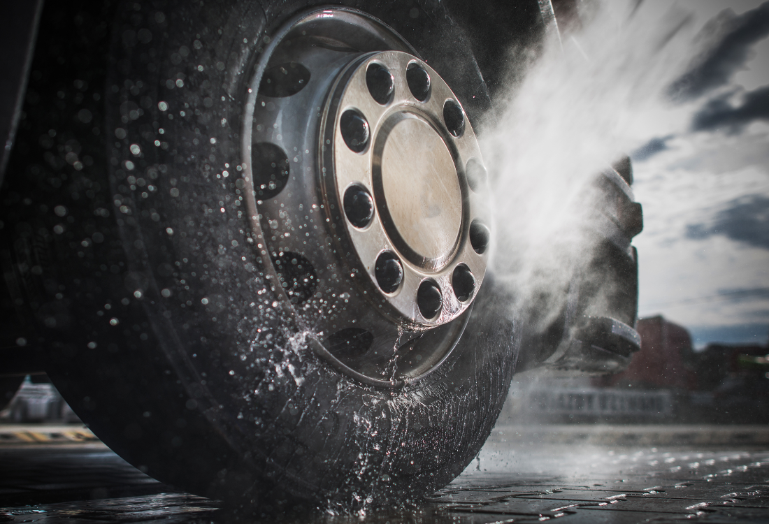 Truck being washed at a commercial fleet wash facility.