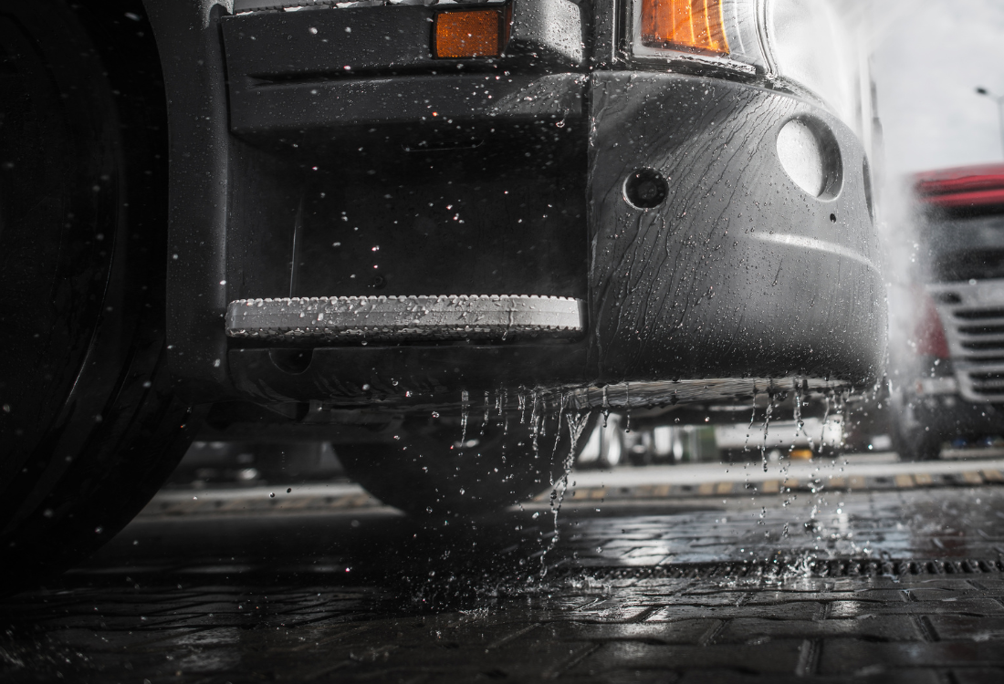 Truck being washed at a commercial vehicle wash facility.