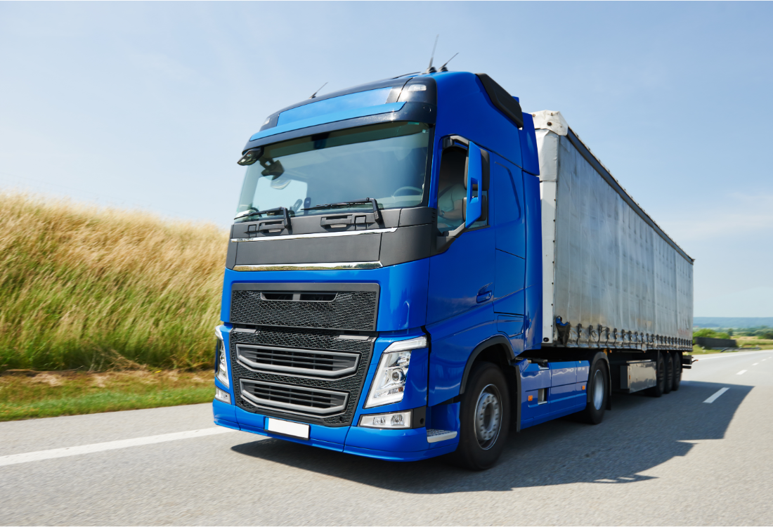 A blue lorry on the road that can be washed with a bus wash system.