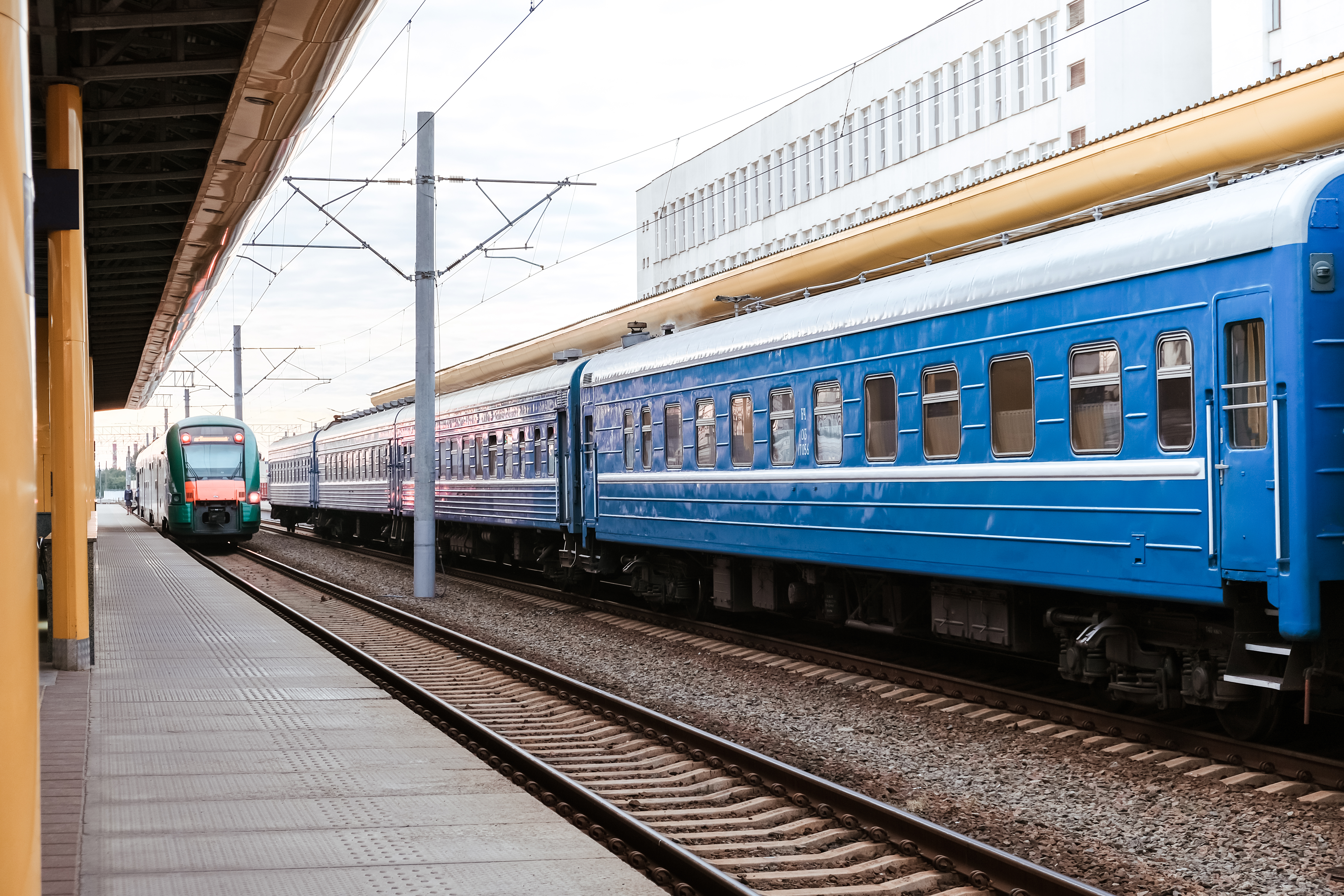 trains at a railway station highlighting the need for an efficient automatic train wash system for fleet maintenance.