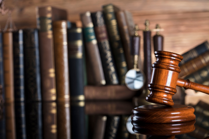Legal gavel and law books, representing the importance of legal compliance and regulations in addressing Legionella risks and ensuring public safety