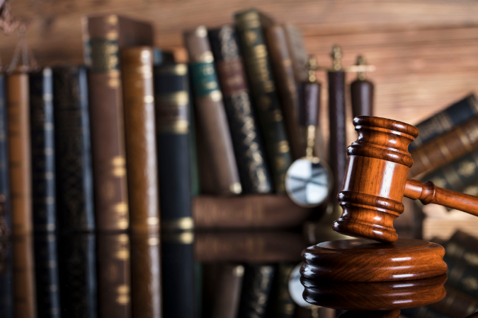  Legal gavel and law books, representing the importance of legal compliance and regulations in addressing Legionella risks and ensuring public safety